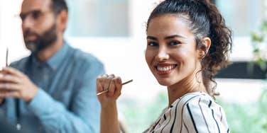 brilliant woman smiling about to shut down mansplainer