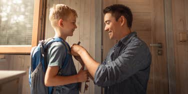 dad getting son ready for school