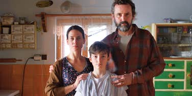 low-income family looking sad standing in home