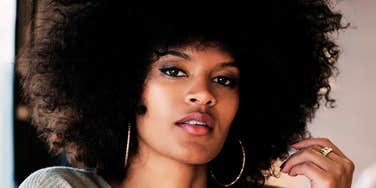 Thoughtful woman with stoic expression, symbolizing reflection on habits and choices that could change her life