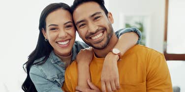 high-value man hugging his partner smiling