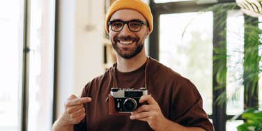 pretentious man showing off photography hobby