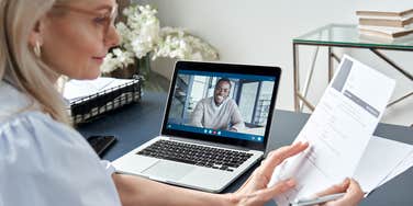 female hr reading resume during video interview