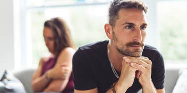 resentful man turned away from successful wife