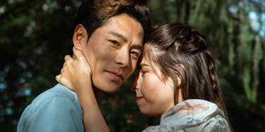 man falling out of love with partner smiling hugging her