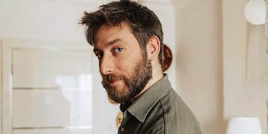 Awkward man, illustrating the strange habits men often have that make it hard to keep a woman interested