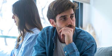upset man feeling invisible as wife ignores him