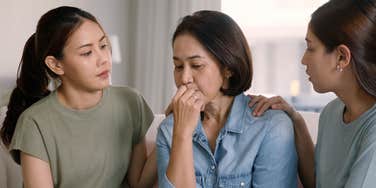 daughters concerned about their mom comforting her