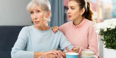 adult daughter concerned for mom sitting in kitchen