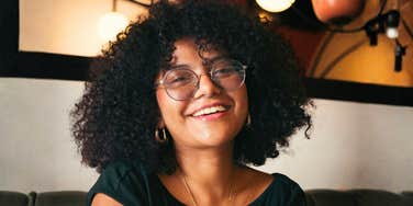 Woman smiling at the camera, reflecting the positive emotional shifts and subtle life changes that show therapy is working.