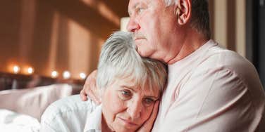 lonely older parents holding each other