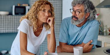 older lonely couple sitting in silence at home