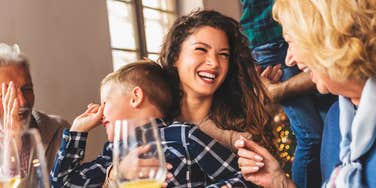 Calm happy family sharing a peaceful holiday meal showing the art of peaceful holiday dinners and how drama-free families keep the peace.