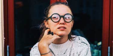 Socially aware person reacting awkwardly showing the phrases people with real social skills know are rude to say to someone single.