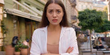 annoyed woman standing on the street