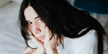 Overwhelmed person showing the messy habits people with executive dysfunction say feel way too familiar.