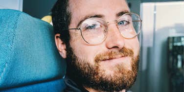 kind calm person offering supportive eye contact, representing personality traits linked to emotional safety and low risk of hurtful behavior.