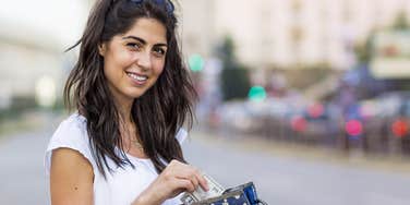 old-school woman carrying cash in her wallet
