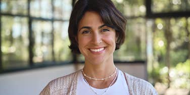 smiling woman practicing astrology and manifesting