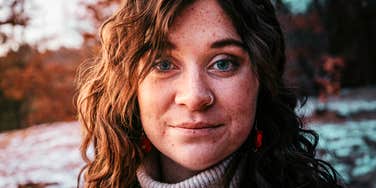 Calm, confident person standing showing how people who ‘get it’ quietly ignore the things society tries to push on them.