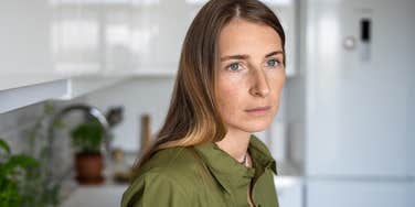 middle aged woman thinking back on being a latchkey kid