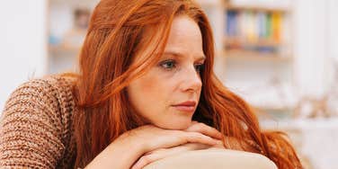 sad woman on couch thinking about her childhood