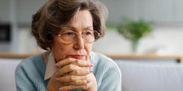 reclusive older woman who rarely goes outside sitting at home