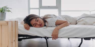young woman sleeping on her stomach 