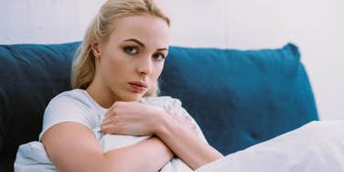 sad woman sitting at home ignoring her family and friends