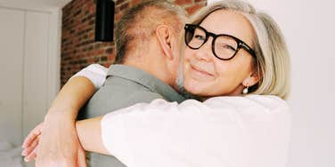 Couple sharing a warm embrace after reconciling, illustrating the gentle phrases and emotional connection of couples who resist big fights.