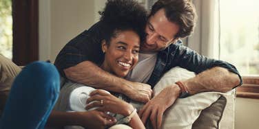 man valuing wife sitting on couch