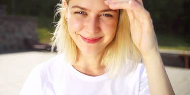 Woman smiling slightly coy showing why certain affirmations are shockingly effective even for skeptics