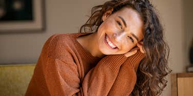 woman who is happy because she spends extra money on small luxuries