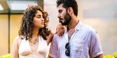 Couple looking at each other while finding a compromise showing the art of social compromise and ways extroverts can stay married to introverts.