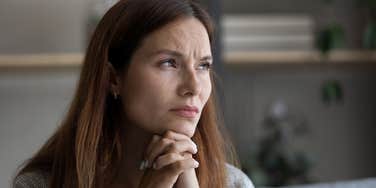 sad woman thinking while hearing background noise