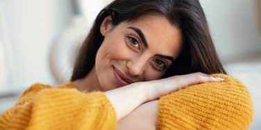 happy woman who stopped posting on social media relaxing at home