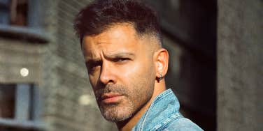 Confident man looking over his shoulder, embodying the firm standards and boundaries of men with true integrity.