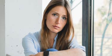 miserable woman sitting at home