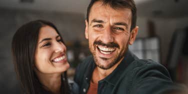 happy couple smiling taking a selfie