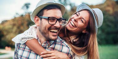 happy couple who are meant to be hugging each other and laughing