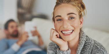 fed up woman forcing a smile in unhappy relationship