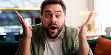 Shocked man looking at the camera showing what men learned from their female roommates about the creepy stuff women face.