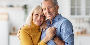 deeply in love older couple hugging and holding hands