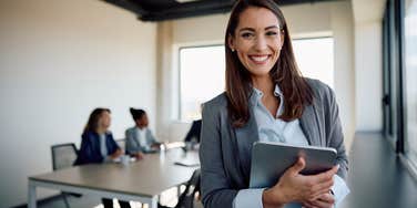 happy businesswoman in a meeting with colleagues