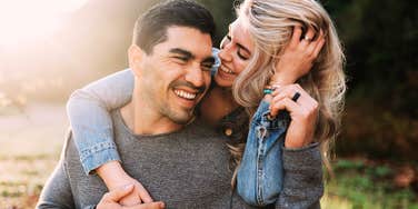 Long-married couple laughing playfully outdoors showing the meaningful milestones that make a marriage stronger by fifty.