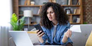 stressed woman looking at finances