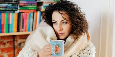 calm cozy person wrapped in winter light with relaxed confidence, illustrating simple unbothered habits that help people stay happy and grounded during the winter months