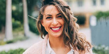 confident successful woman smiling with grounded ease, capturing the simple habits that help high-achieving women get everything they want in life — including love