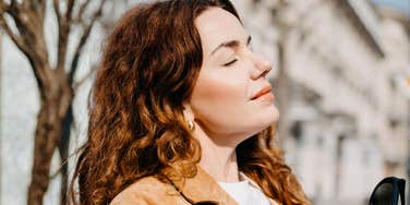 anxious person taking a slow grounding breath with soft light around them, capturing the simple techniques that create instant calm before anxiety can hijack daily life
