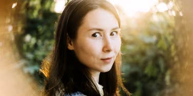 serene person surrounded by soft light and calm energy, illustrating gentle ways to recharge the spirit and cleanse the aura for emotional and energetic renewal